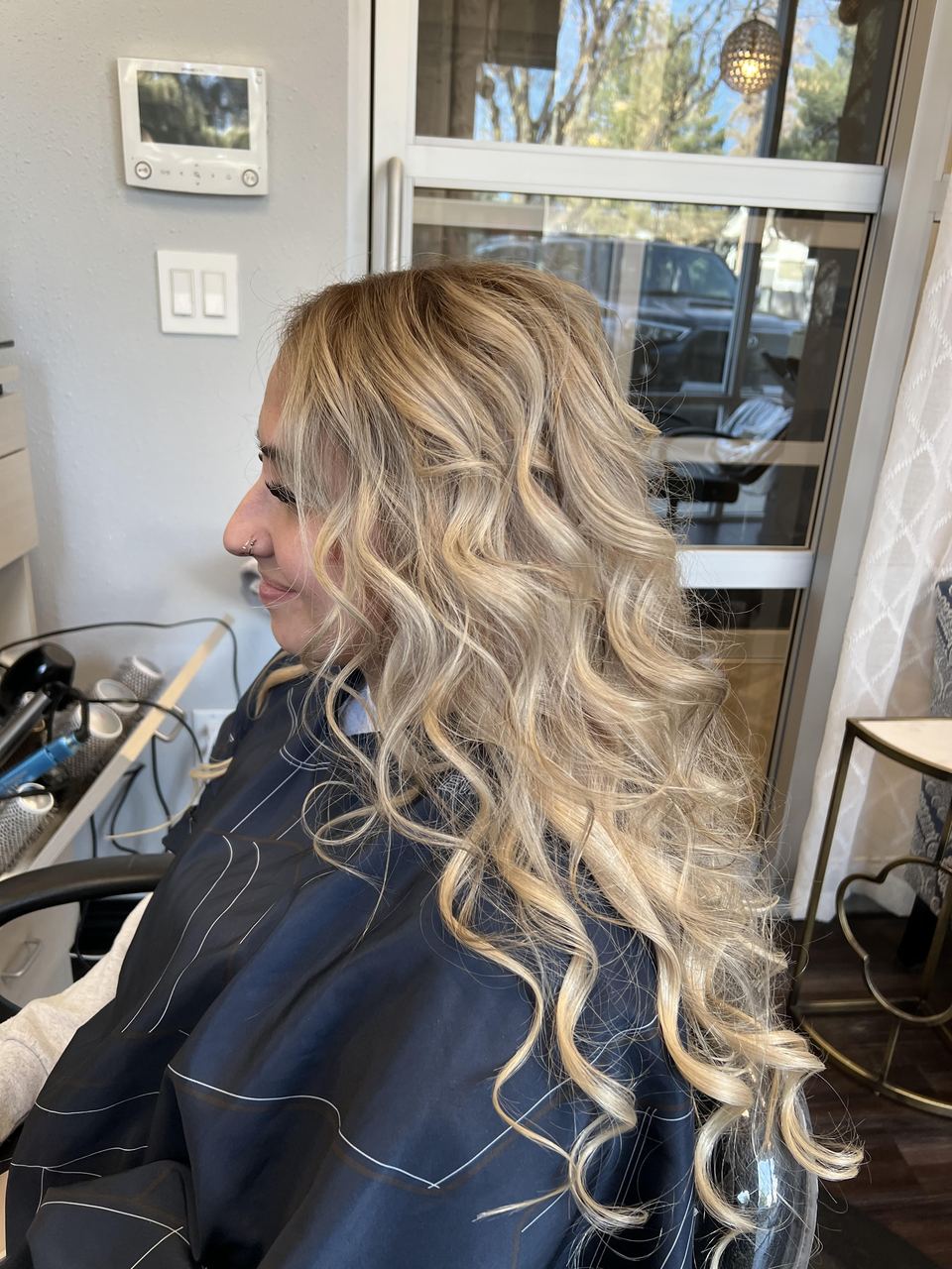 Dimensional blonde result styled in soft waves