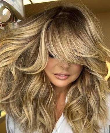 Voluminous blonde style with long layers and bright face-framing pieces