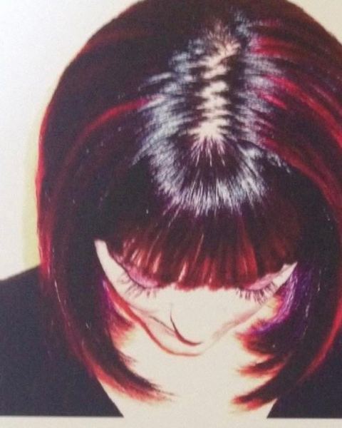 Chin-length precision bob with dimensional red and violet color placement